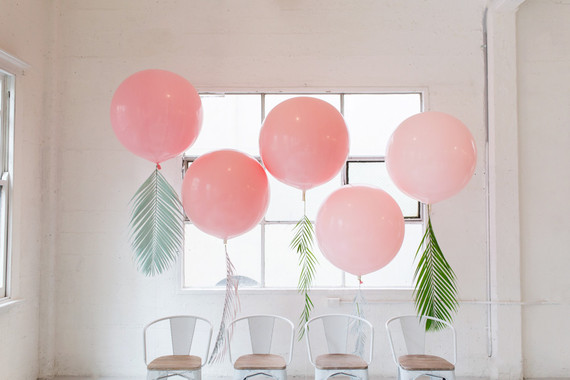 Pink balloons with tropical foliage
