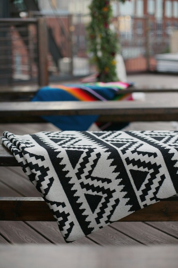 Wooden benches draped in serape blankets