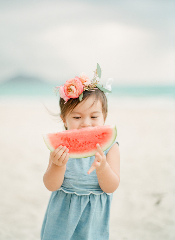 little girls on the beach with flower crowns and watermelon