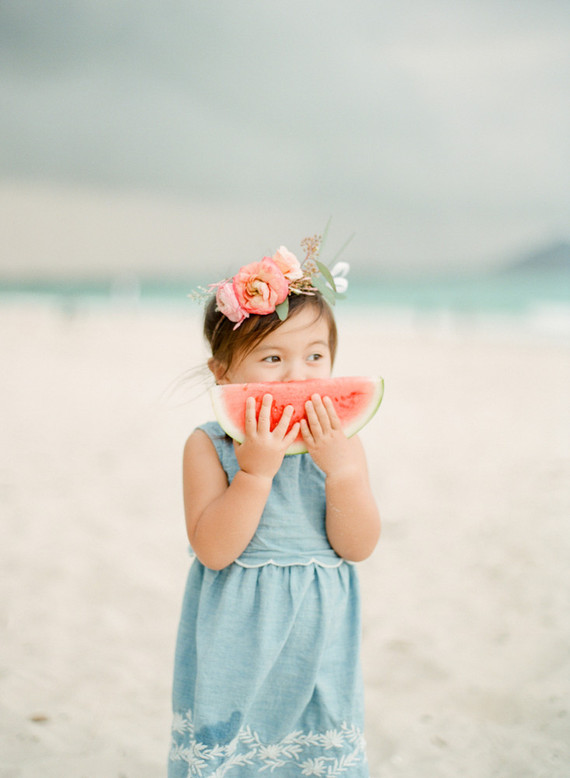 little girls on the beach with flower crowns and watermelon