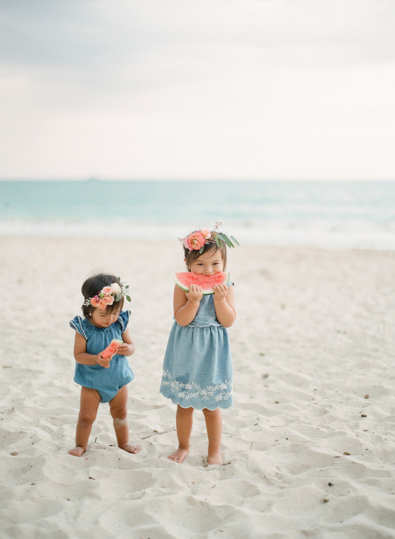 little girls on the beach with flower crowns and watermelon
