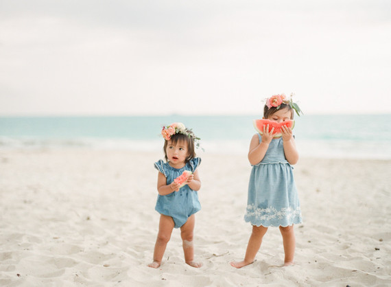 little girls on the beach with flower crowns and watermelon