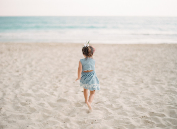 little girls on the beach with flower crowns and watermelon
