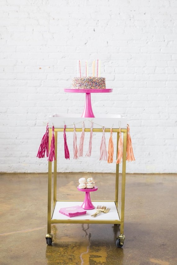 sprinkles birthday cake on a bar cart
