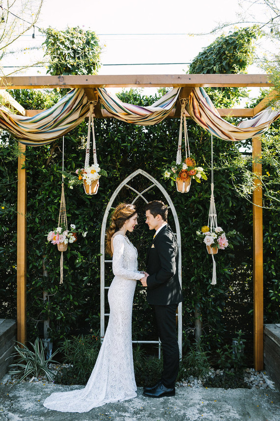 eclectic ceremony decor with macrame plant holders Inspiration