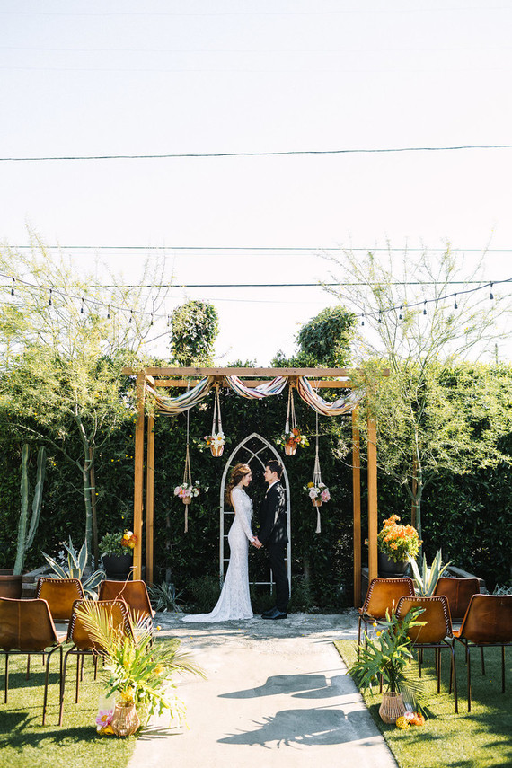 eclectic ceremony decor with macrame plant holders Inspiration