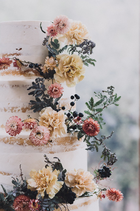Tiered layer cake with strawflowers and chrysanthemums