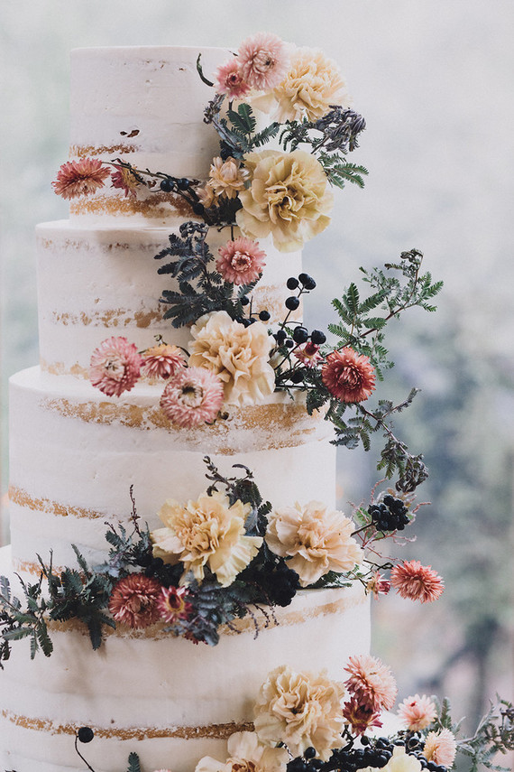 Tiered layer cake with strawflowers and chrysanthemums