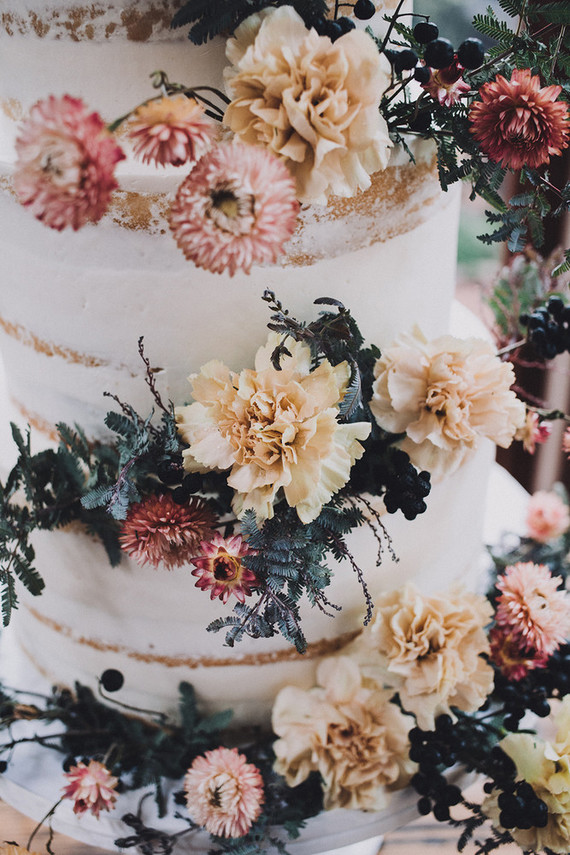 Tiered layer cake with strawflowers and chrysanthemums