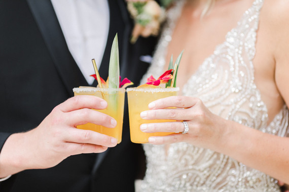 Colorful modern wedding with a killer tropical floral installation