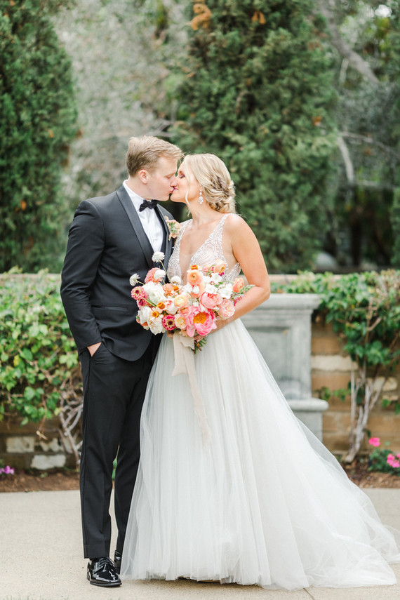 Colorful modern wedding with a killer tropical floral installation