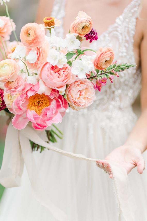 Colorful modern wedding with a killer tropical floral installation