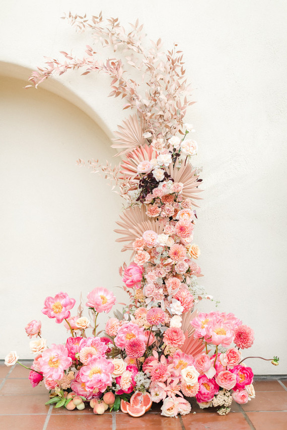 Colorful modern wedding with a killer tropical floral installation