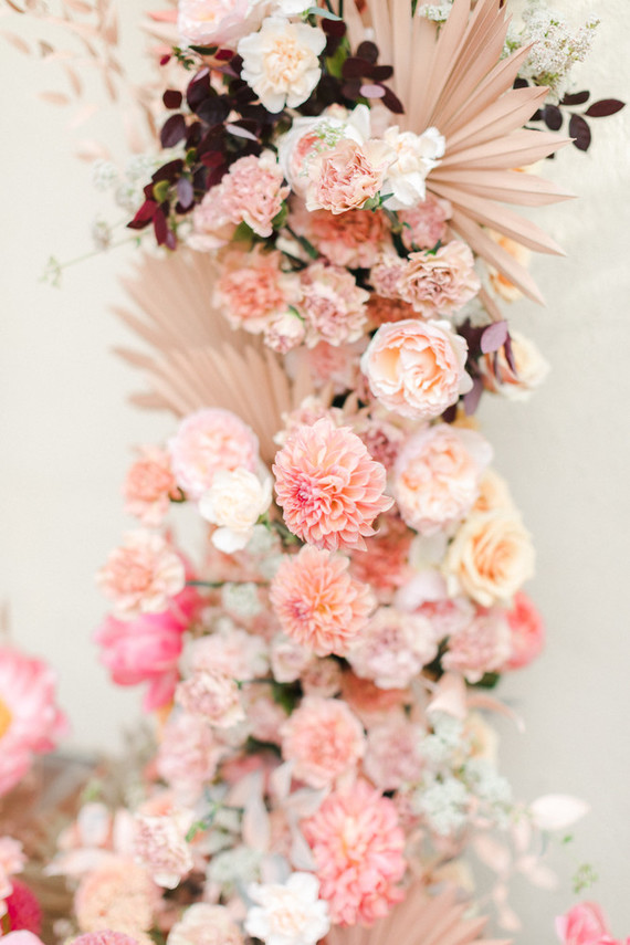 Colorful modern wedding with a killer tropical floral installation