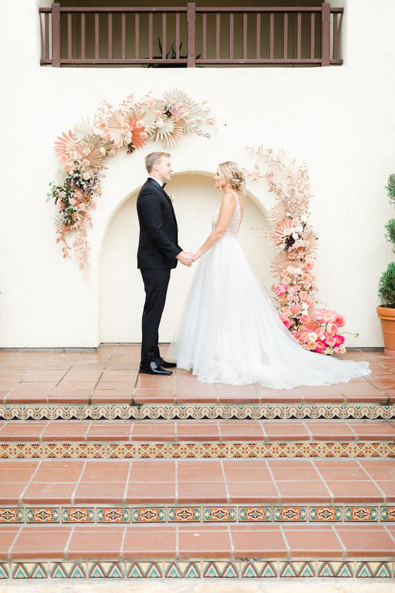 Colorful modern wedding with a killer tropical floral installation