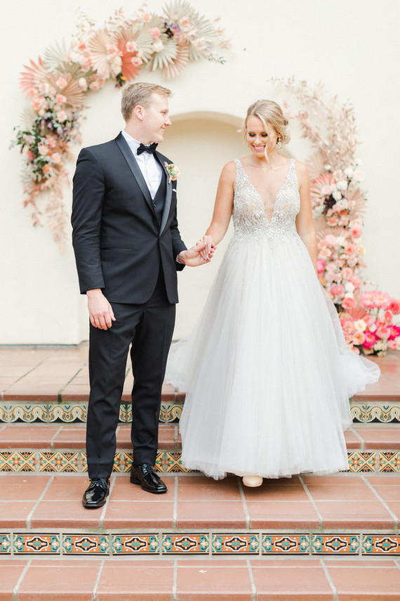 Colorful modern wedding with a killer tropical floral installation