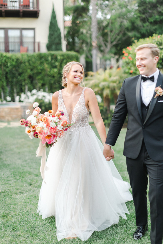 Colorful modern wedding with a killer tropical floral installation