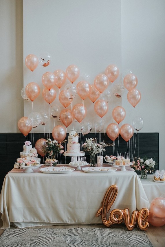 Pink baby shower with lots of balloons
