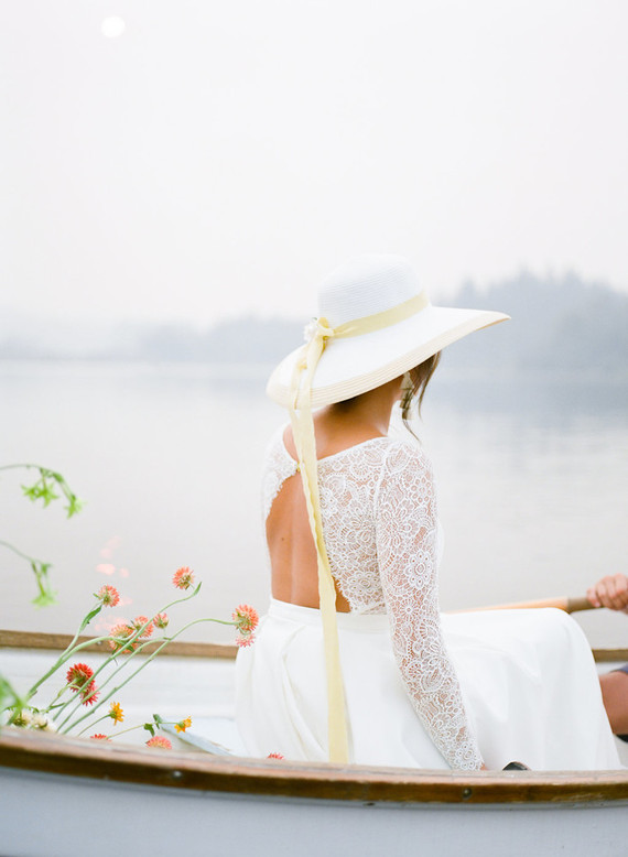 End of summer retro engagement shoot in a rowboat full of flowers