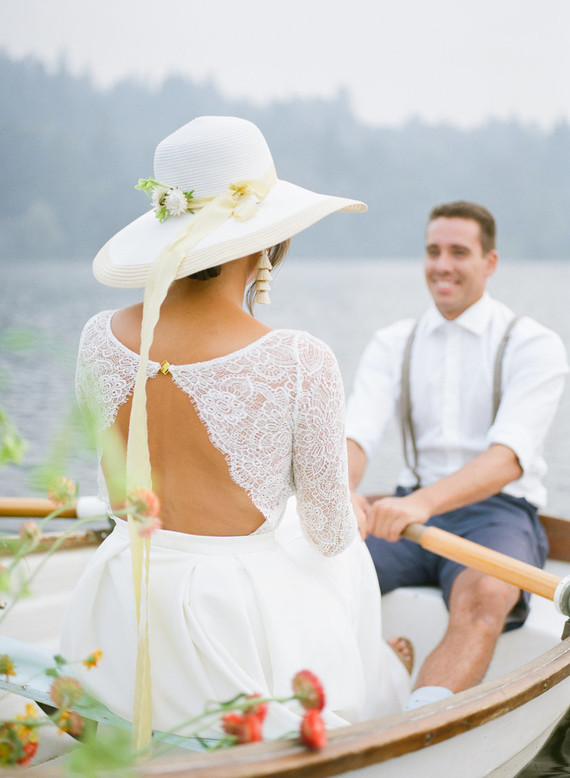 End of summer retro engagement shoot in a rowboat full of flowers