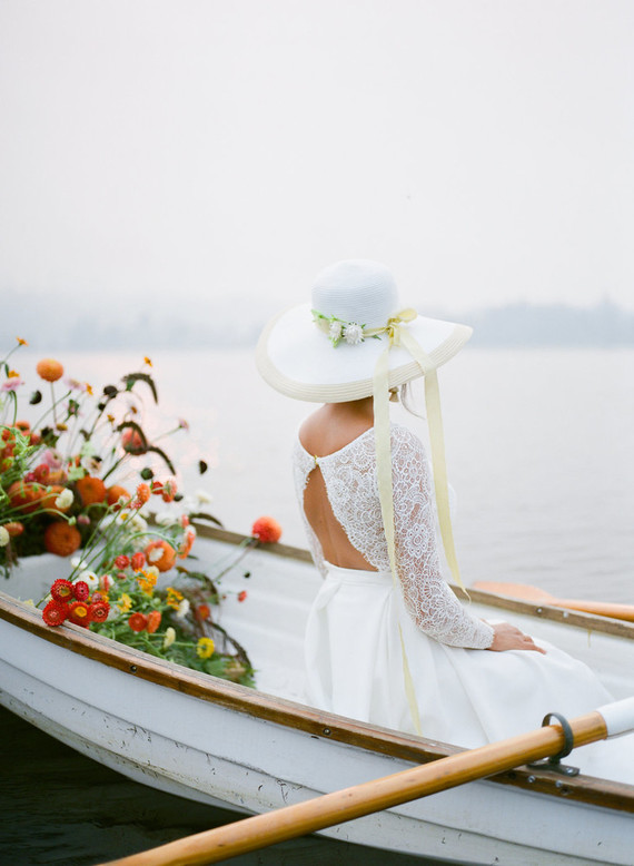 End of summer retro engagement shoot in a rowboat full of flowers