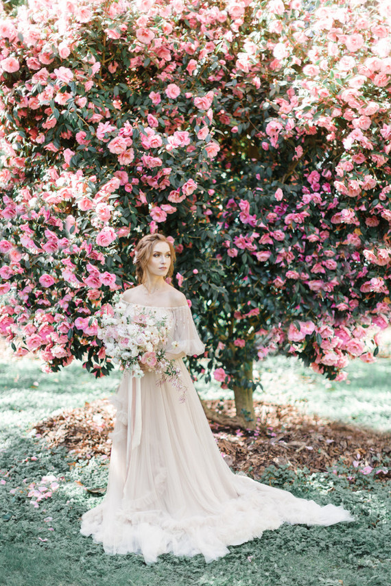 A stunning bridal editorial with a giant pink camellia tree