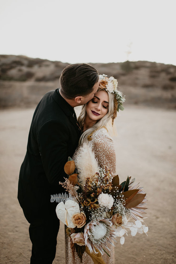 Boho vow renewal with a palm frond teepee at Wolf Feather Honey Farm