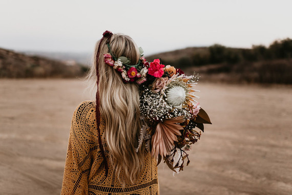 Boho vow renewal with a palm frond teepee at Wolf Feather Honey Farm