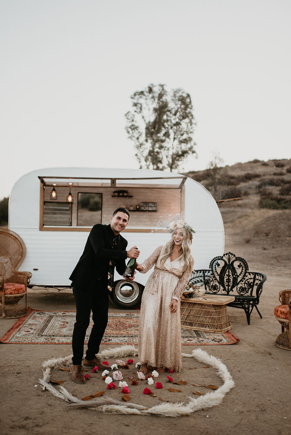 Boho vow renewal with a palm frond teepee at Wolf Feather Honey Farm