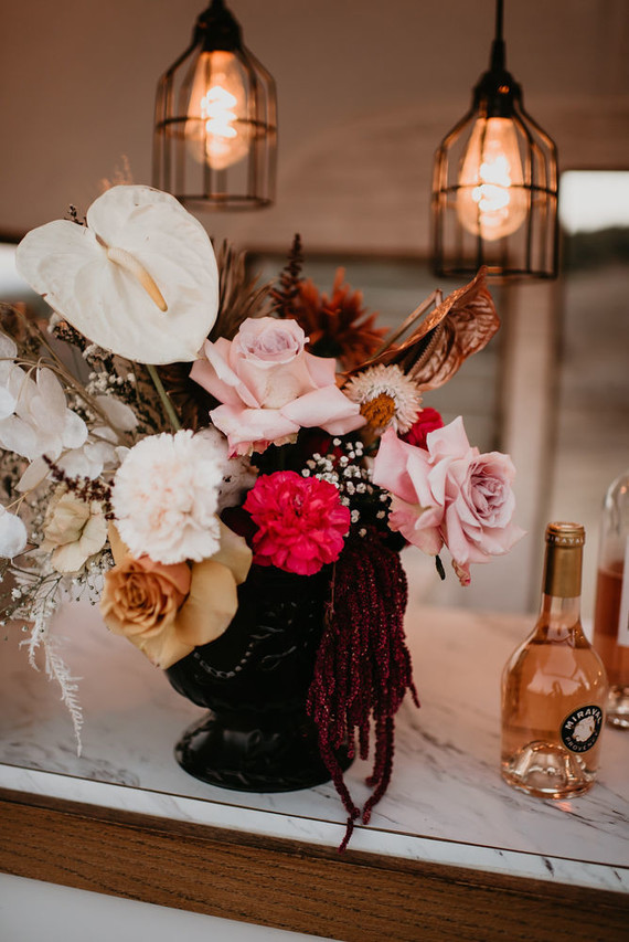 Boho vow renewal with a palm frond teepee at Wolf Feather Honey Farm