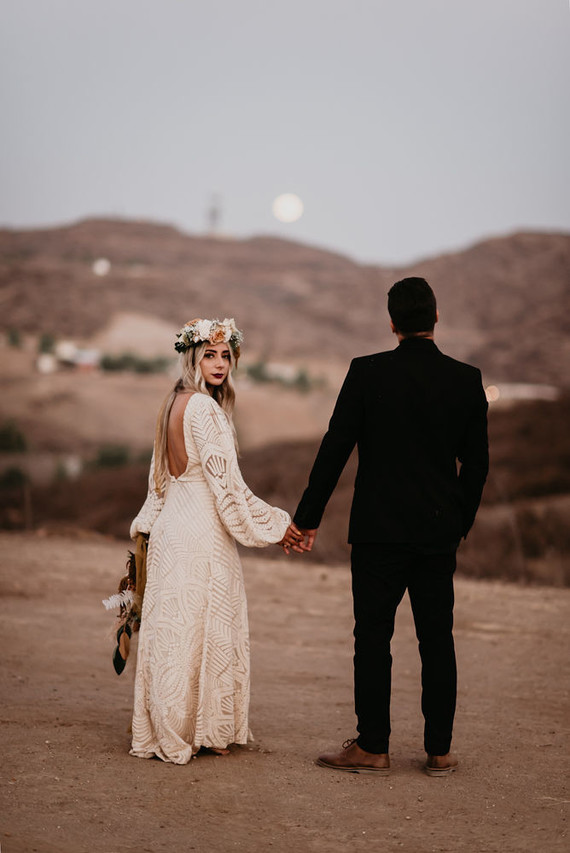 Boho vow renewal with a palm frond teepee at Wolf Feather Honey Farm