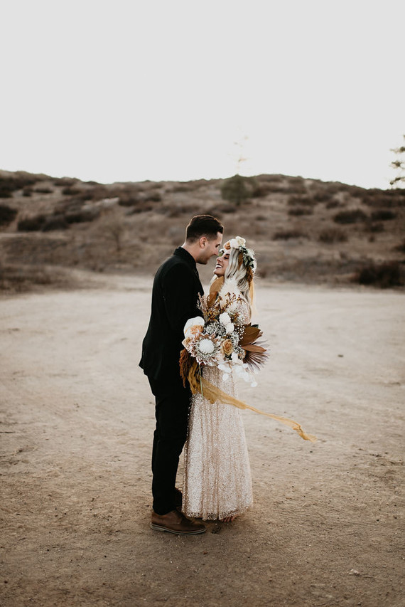 Boho vow renewal with a palm frond teepee at Wolf Feather Honey Farm
