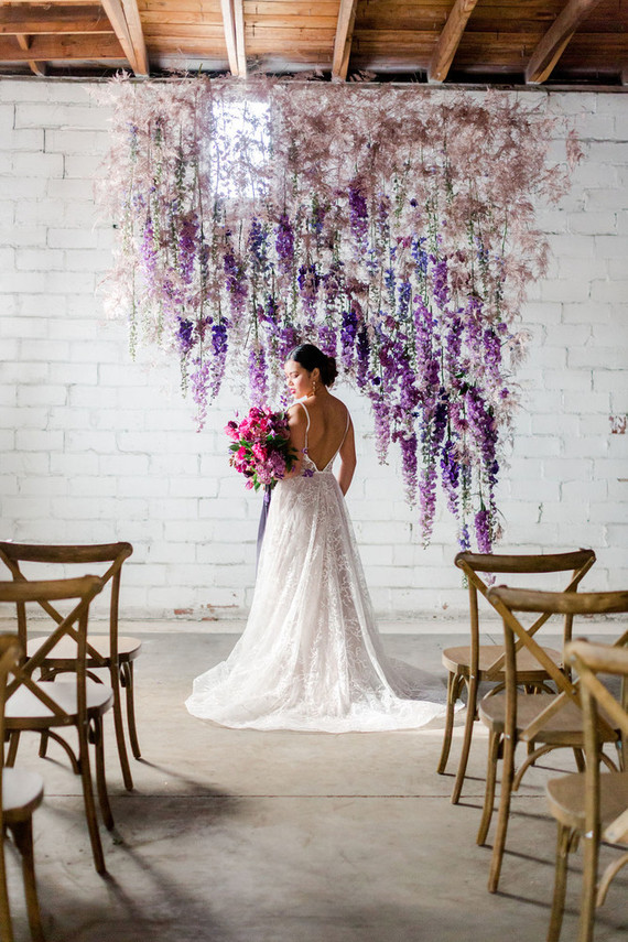 Bright moody spring wedding inspo with a dramatic floral curtain Inspiration