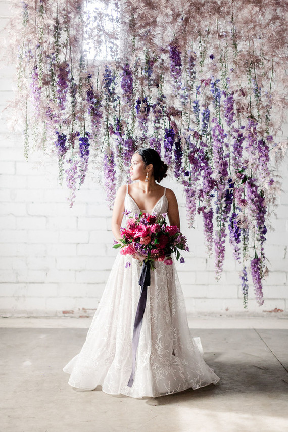 Bright moody spring wedding inspo with a dramatic floral curtain