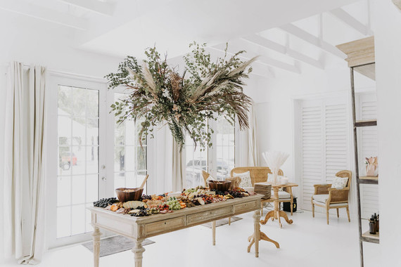 All white olive branch bridal shower with an epic grazing table