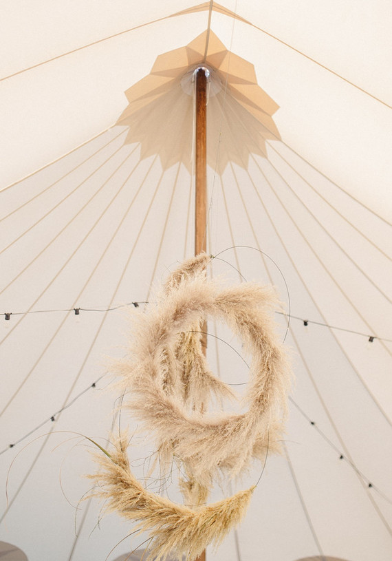 wedding tent with pampas grass wreaths