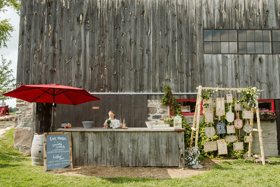 Farm to table summer barn wedding with pops of red and a PARADE