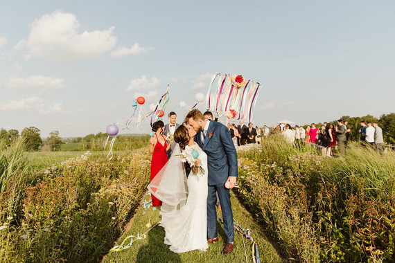 Farm to table summer barn wedding with pops of red and a PARADE