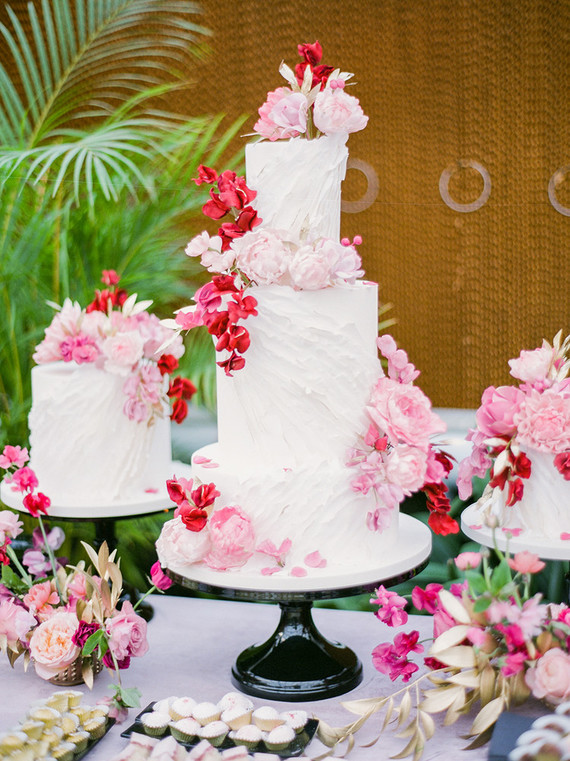Ruffled floral wedding cake with pink details