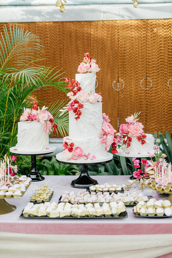 Ruffled floral wedding cake with pink details