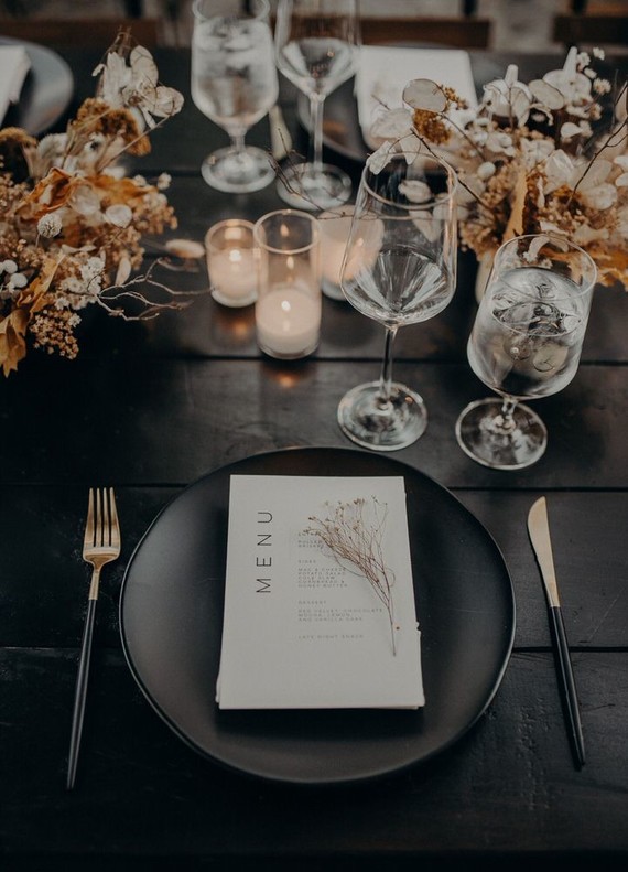 black place setting with dried flowers