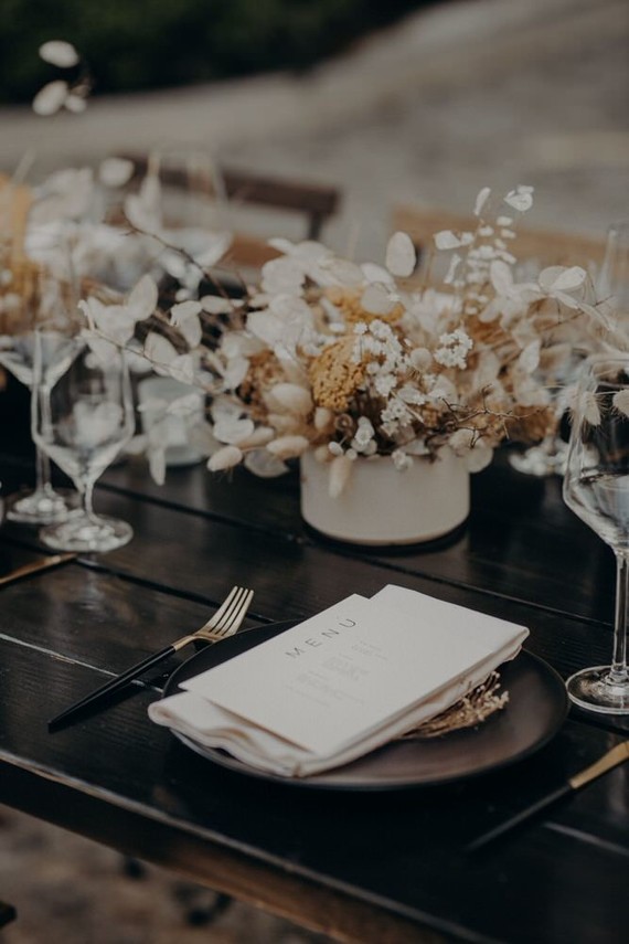 black place setting with dried flowers