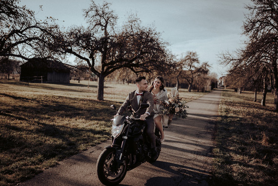 Bride and groom on motorcycle
