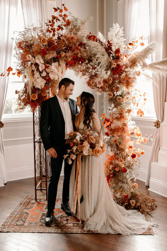 Lush fall floral ceremony arch