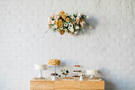 hanging florals above dessert table