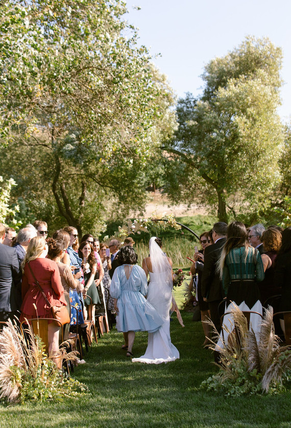 mom and daughter walking down the aisle