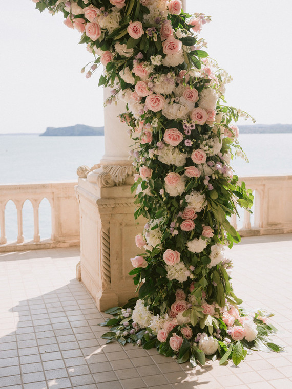 pink floral arch for ceremony