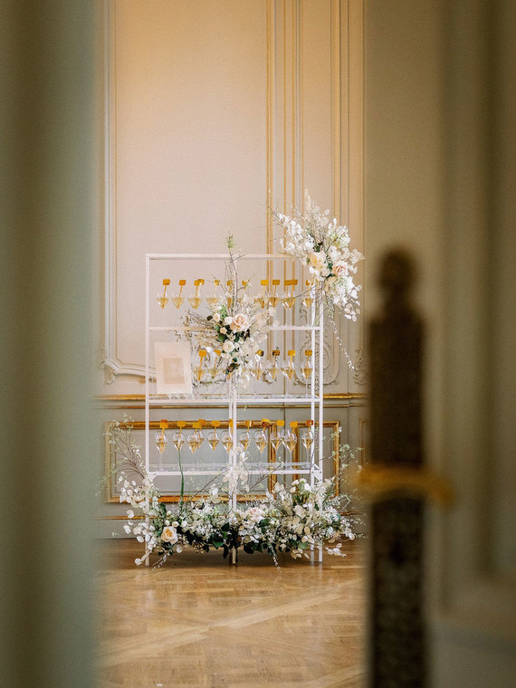 Champagne escort card display with gold drink stirs