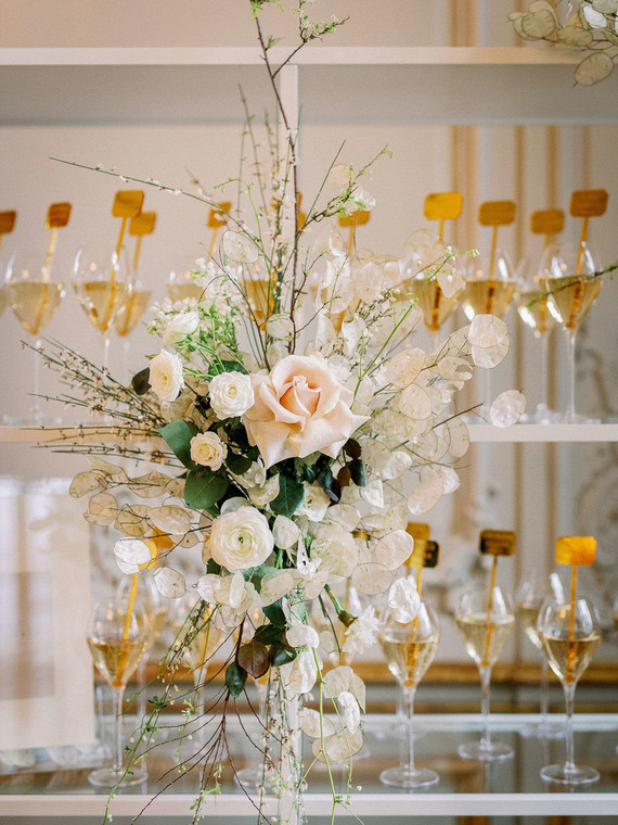 Champagne escort card display with gold drink stirs