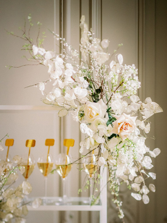 Champagne escort card display with gold drink stirs